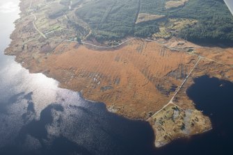 Oblique aerial view of the partially constructed Loch Doon airfield, showing the complex arrangement of field drains used to drain the peaty ground and site of an airplane hanger, looking SSW.