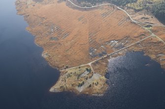 Oblique aerial view of the partially constructed Loch Doon airfield, showing the complex arrangement of field drains used to drain the peaty ground and site of an airplane hanger, looking S.