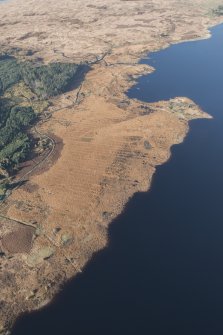 Oblique aerial view of the partially constructed Loch Doon airfield, showing the complex arrangement of field drains used to drain the peaty ground and site of an airplane hanger, looking NW.