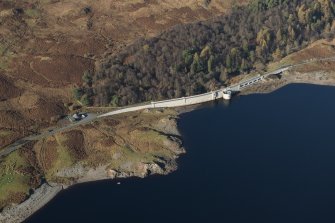 Oblique aerial view of Loch Doon Dam and military site, looking NW.