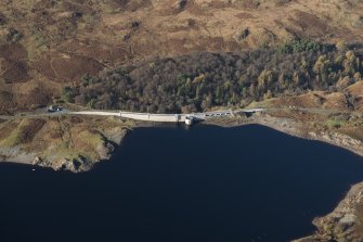 Oblique aerial view of Loch Doon Dam and military site, looking W.