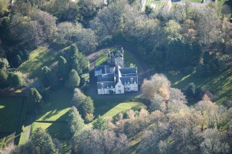 Oblique aerial view of Kirkhill House and Kirkhill Castle, looking SE.