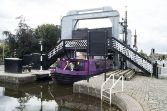 General view of Leamington Lifting Bridge, Union Canal, Gilmore Park, Edinburgh, in raised position with a barge passing through, from the north-east
