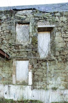 Exterior. Detail of windows and doorway on north elevation.