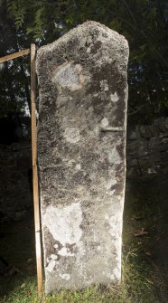 View of relief-carved cross slab. Peripheral lighting. (with scale)