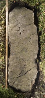 View of recumbent cross slab. Peripheral lighting. (with scale.)
