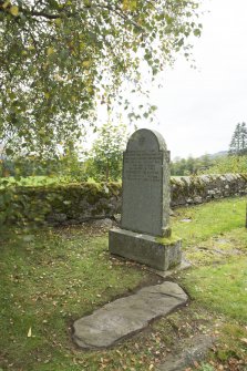 View of recumbent cross slab in churchyard.