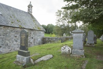 View of recumbent cross slab in churchyard.