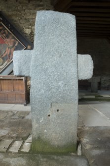 View of cruciform stone situated inside church.