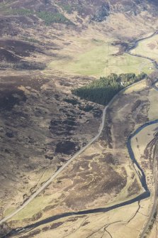 Oblique aerial view of the Dunkeld to Inverness Military Road and Crubenmore Lodge, looking SSW.