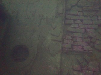 View of galley bricks on steamship Minieh. Nearby circular aperture maybe a mast step