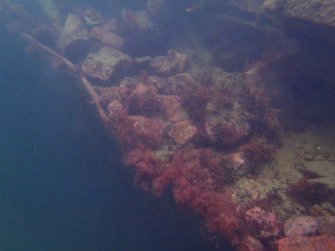 View of rock ballast and hull plating on steamship Numidian