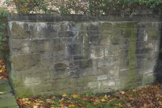 Detail of boundary wall in rear courtyard of Canongate Housing, 97-103 Canongate, Edinburgh. The stone for the walling in the rear courtyard may be reused from the tenements which were demolished to make way for this development.