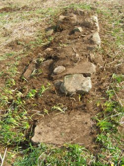 TOR4.3.11 Clearing the footings of one of the walls reveals its thickness as 0.09m.