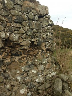 Knockdavie Castle. Detail of western half of northern wall showing blocked opening and evidence of first floor.