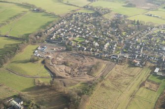 Oblique aerial view of the housing estate under construction at the NE end of Biggar, looking SE.