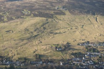 Oblique aerial view of Leadhills village, the mining remains and field systems, looking W.