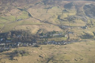 Oblique aerial view of Leadhills, the mining remains and the field systems, looking W.