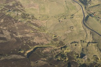 Oblique aerial view of the mining remains and field systems, looking ENE.