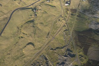 Oblique aerial view of the mining remains and field systems, looking NNW.