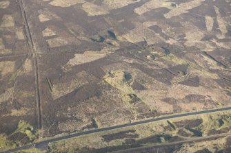 Oblique aerial view of the mining remains on the E flank of Wanlock Dod, looking NW.