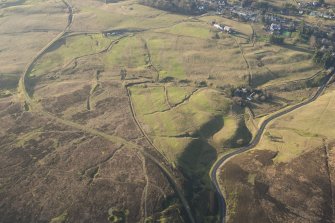 Oblique aerial view of Leadhills Golf Course, the mining remains and the field systems, looking SW.