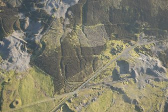 Oblique aerial view of the mining and building remains at NS 8856 1398, looking SE.