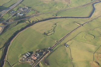 Oblique aerial view of the settlement and the motte and bailey, looking WNW.