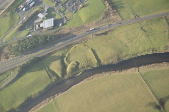 Oblique aerial view of the remains of the motte and bailey, looking WNW.