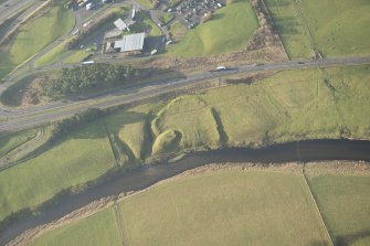 Oblique aerial view of the remains of the motte and bailey, looking WNW.