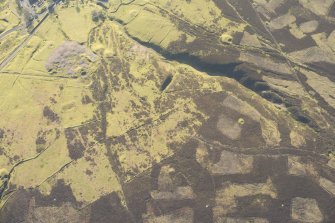 Oblique aerial view of Wanlockhead and mining remains, looking WSW.