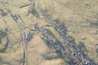 Oblique aerial view of the mining remains and Leadhills village, looking SW.