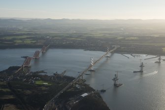 General oblique aerial view of the Forth Bridge, the Forth Road Bridge and the construction of the Queensferry Crossing, looking SSE.
