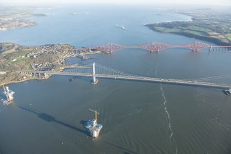 General oblique aerial view of the Forth Bridge, the Forth Road Bridge and the construction of the Queensferry Crossing, looking E.