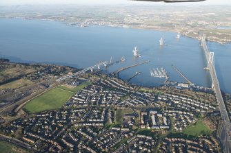 General oblique aerial view of the Forth Road Bridge and the construction of the Queensferry Crossing, looking NNW.