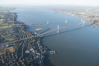 General oblique aerial view of the Forth Road Bridge and the construction of the Queensferry Crossing, looking WNW.