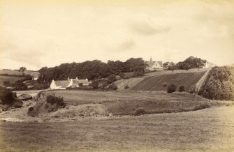 View of houses in Fenwick village with Fenwick Parish Church in distance. 
