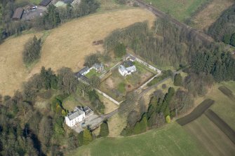 Oblique aerial view of Wyseby House, walled garden, stables and dovecot, looking NW.