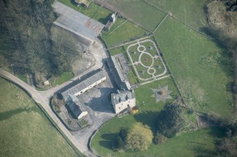 Oblique aerial view of Buittle Place Tower House, looking NE.