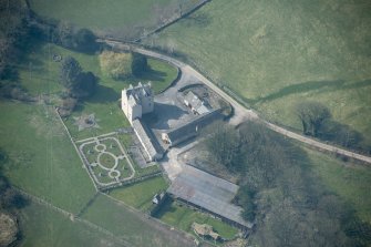 Oblique aerial view of Buittle Place Tower House, looking SW.