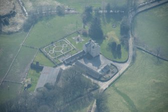 Oblique aerial view of Buittle Place Tower House, looking SE.