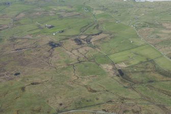 General oblique aerial view of croftland at Kilkenneth with the military camp at Creagan House beyond, looking SW.