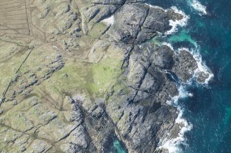 Oblique aerial view of Dun Boraige Moire on Tiree, looking SW.