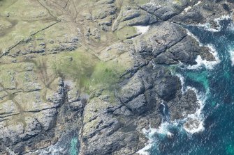 Oblique aerial view of Dun Boraige Moire on Tiree, looking SSW.