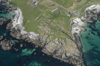 Oblique aerial view of Hynish Lighthouse shore establishment on Tiree, looking WNW.