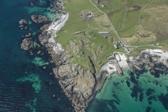 Oblique aerial view of Hynish Lighthouse shore establishment and harbour on Tiree, looking WSW.