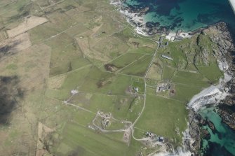 General oblique aerial view of Hynish on Tiree, looking NNE.