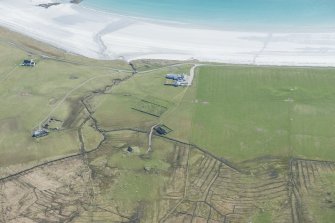 Oblique aerial view of the old parish church and cemetery at Kirkapol on the Isle of Tiree, looking SE.
