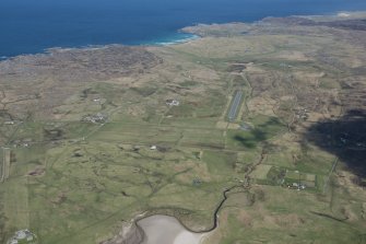 General oblique aerial view of Coll centred on the airfield, looking NNE.