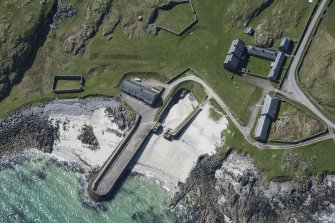 Oblique aerial view of Hynish Harbour on the Isle of Tiree, looking SW.